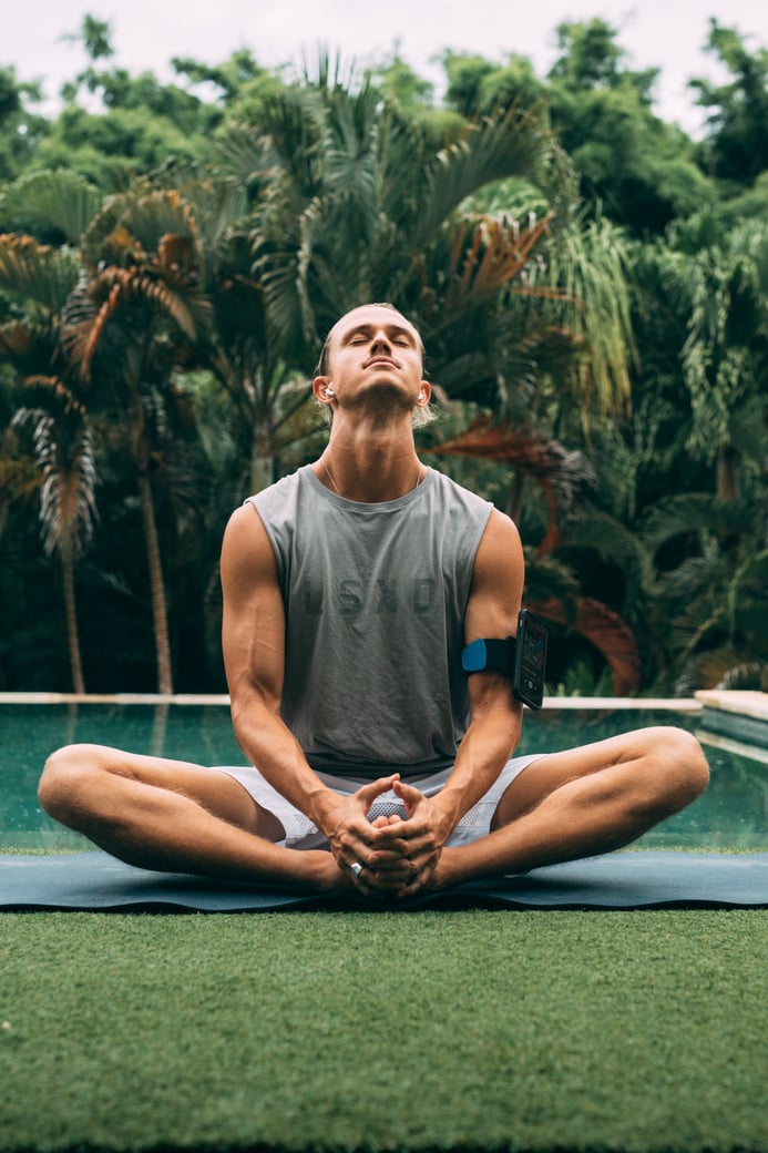 Man Sitting by the Poolside in Yoga Pose